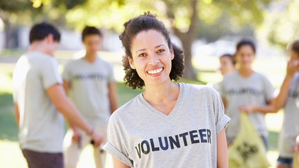 Senior leader smiling, wearing a volunteer t-shirt.