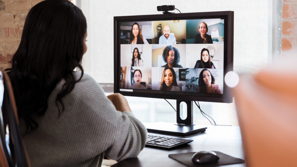 female in front of a computer leading a virtual meeting